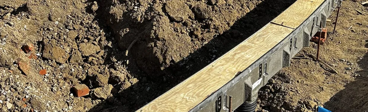 Excavated trench with formwork on a commercial job site