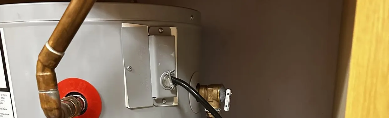 Copper water lines connected to a tank water heater in a home